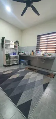 a living room with a ceiling fan and a checkered floor at REZEKI MUEZZA 3BR2B Cozy Homestay in Teluk Intan