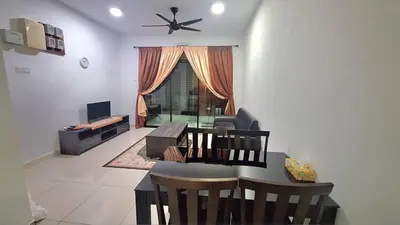 a living room with a table and a dining room at A well-kept unit with four bedrooms and ensuite bathrooms in Kampar
