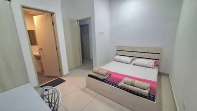 a bedroom with a bed in a room at A well-kept unit with four bedrooms and ensuite bathrooms in Kampar