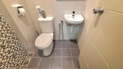 a bathroom with a toilet and a sink at A well-kept unit with four bedrooms and ensuite bathrooms in Kampar