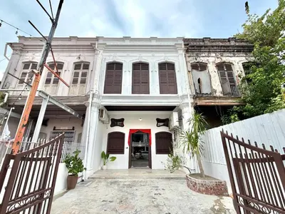 an old white house with a red door at Love Linn in George Town