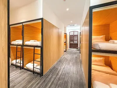 a room with three bunk beds and a hallway at Love Linn in George Town