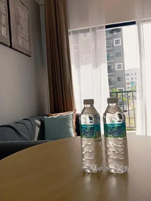 two bottles of water sitting on top of a table at Radif Homestay Seri Iskandar with Balcony#2 in Kampong Bota Road