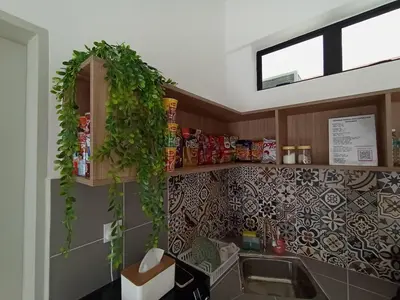 a kitchen with a sink and plants on the wall at Radif Homestay Seri Iskandar with Balcony#2 in Kampong Bota Road