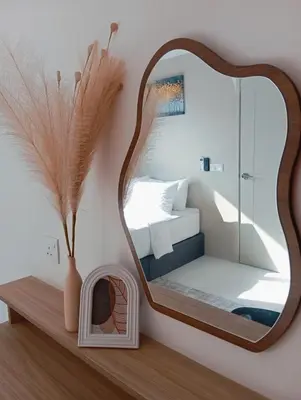 a mirror on a shelf with a bed in a bedroom at Radif Homestay Seri Iskandar with Balcony#2 in Kampong Bota Road
