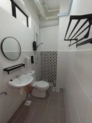 a bathroom with a white toilet and a sink at Radif Homestay Seri Iskandar with Balcony#2 in Kampong Bota Road