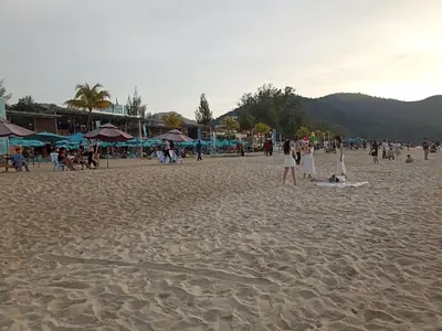 a group of people on a sandy beach at Sri Sayang Batu Ferringhi 4 Bed in Batu Ferringhi