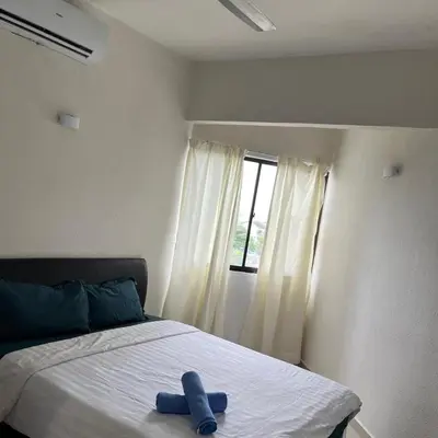 a blue ribbon sitting on a bed in a bedroom at Sri Sayang Batu Ferringhi 4 Bed in Batu Ferringhi