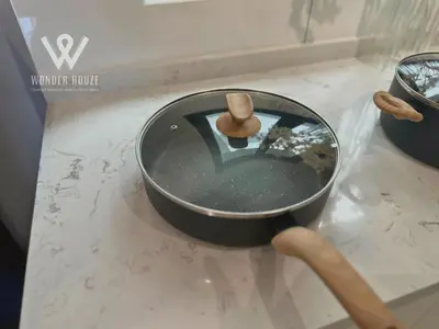 a pan with a wooden spoon in it on a counter at Modern 3BR Retreat at Bandar Baru Air Itam near Air Itam and Kek Lok Si in Ayer Itam