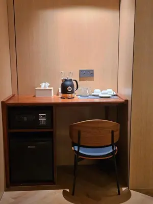 a small desk with a chair and a microwave at The Green Hall in George Town