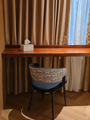 a chair sitting under a desk with a shelf at The Green Hall in George Town