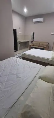 a room with two beds and a couch at Cozy Nook in George Town