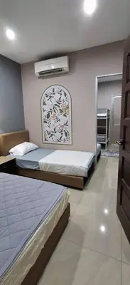 a bedroom with two beds and a window in it at Cozy Nook in George Town