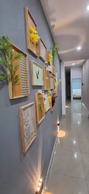 a hallway with paintings and pictures on a wall at Cozy Nook in George Town