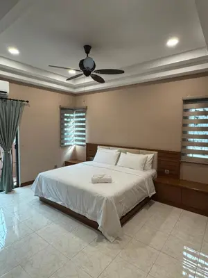 a bedroom with a bed with a ceiling fan at Ichinichi Home in Ipoh