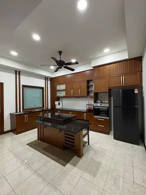 a large kitchen with wooden cabinets and a ceiling fan at Ichinichi Home in Ipoh