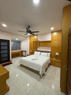 a bedroom with a bed and a ceiling fan at Ichinichi Home in Ipoh