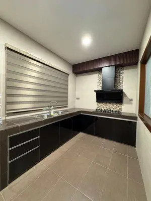 a large kitchen with a sink and a microwave at Ichinichi Home in Ipoh