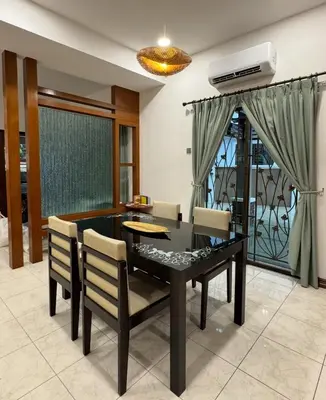 a dining room with a table and chairs at Ichinichi Home in Ipoh