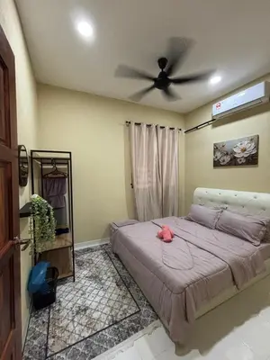a bedroom with a bed with a ceiling fan at Welcome To Amda CS Guest House