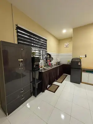 a kitchen with a sink and a refrigerator at Welcome To Amda CS Guest House