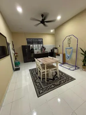 a living room with a table and a ceiling fan at Welcome To Amda CS Guest House