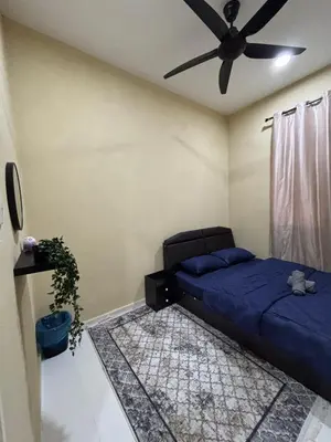 a bedroom with a bed and a ceiling fan at Welcome To Amda CS Guest House