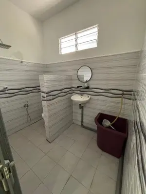 a bathroom with a sink and a mirror at Welcome To Amda CS Guest House