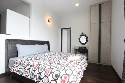 a bedroom with a large bed and a mirror at Shamrock Beach Villas 15 Seaview in George Town