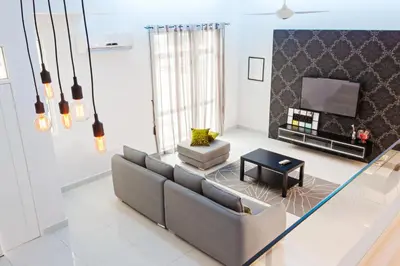 a living room with a couch and a tv at Shamrock Beach Villas 15 Seaview in George Town
