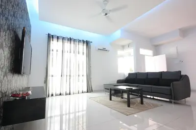 a living room with a couch and a table at Shamrock Beach Villas 15 Seaview in George Town