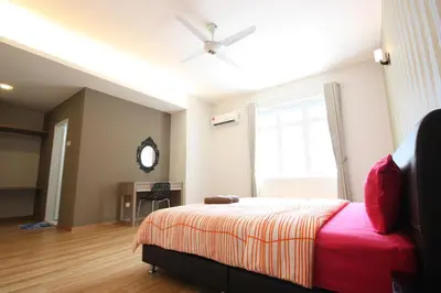 a bedroom with a bed and a window and a desk at Shamrock Beach Villas 9 Seaview in George Town