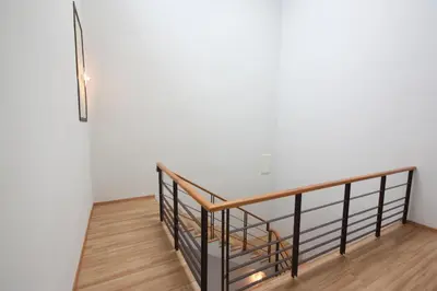 a staircase in a white room with a metal railing at Shamrock Beach Villas 9 Seaview in George Town