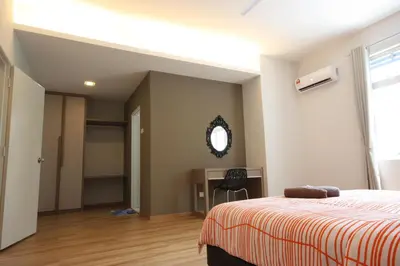 a bedroom with a bed and a desk and a mirror at Shamrock Beach Villas 9 Seaview in George Town
