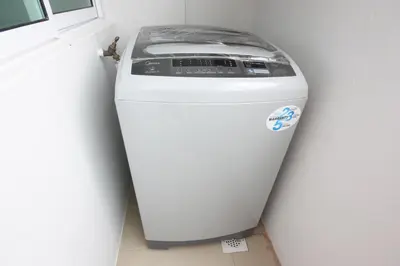 a washing machine sitting in a corner next to a wall at Shamrock Beach Villas 9 Seaview in George Town