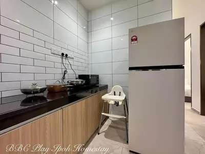 a kitchen with a refrigerator and a counter top at BBC Play Ipoh Homestay in Ipoh