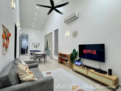 a living room with a couch and a tv at BBC Play Ipoh Homestay in Ipoh