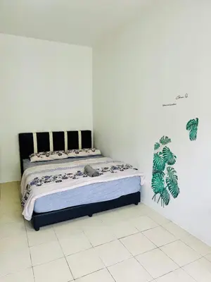 a bedroom with a bed in a white room at AYAAN LAVENDER Homestay with PS4 Gaming and Netflix at Tanah Rata Cameron Highland in Tanah Rata