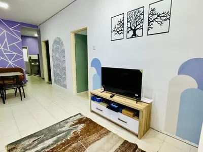 a living room with a flat screen tv on a wall at AYAAN LAVENDER Homestay with PS4 Gaming and Netflix at Tanah Rata Cameron Highland in Tanah Rata