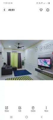 a picture of a living room with a tv at Hakim Homestay in Hutan Melintang