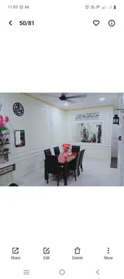 a dining room with a table and chairs at Hakim Homestay in Hutan Melintang