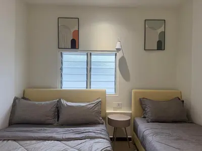 a bedroom with two beds and a window at MR Homestay HotelStyle Room Hutan Melintang in Hutan Melintang