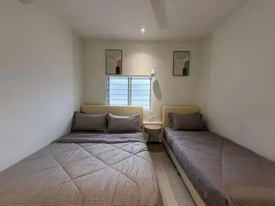 a bedroom with two beds and a window at MR Homestay HotelStyle Room Hutan Melintang in Hutan Melintang