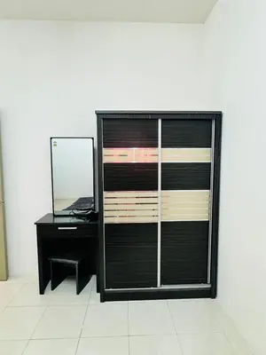a black dresser with a mirror and a desk at Ayaan Family Retreat with PS4 and Netflix in Tanah Rata