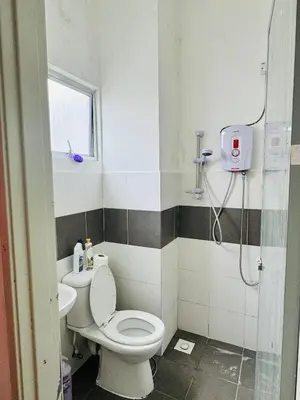a bathroom with a toilet and a sink and a shower at Ayaan Family Retreat with PS4 and Netflix in Tanah Rata