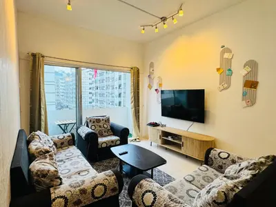 a living room with couches and a flat screen tv at Ayaan Family Retreat with PS4 and Netflix in Tanah Rata