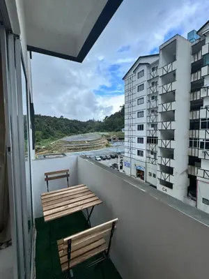 a balcony with a bench and a view of a building at Ayaan Family Retreat with PS4 and Netflix in Tanah Rata