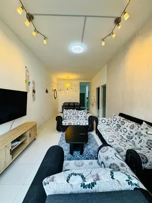 a living room with a couch and a flat screen tv at Ayaan Family Retreat with PS4 and Netflix in Tanah Rata