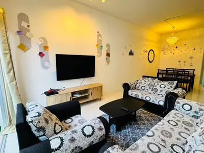 a living room with couches and a flat screen tv at AYAAN HOLIDAY INN Homestay at Tanah Rata with PS4 gaming in Tanah Rata