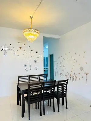 a dining room with a table and chairs and a chandelier at AYAAN HOLIDAY INN Homestay at Tanah Rata with PS4 gaming in Tanah Rata